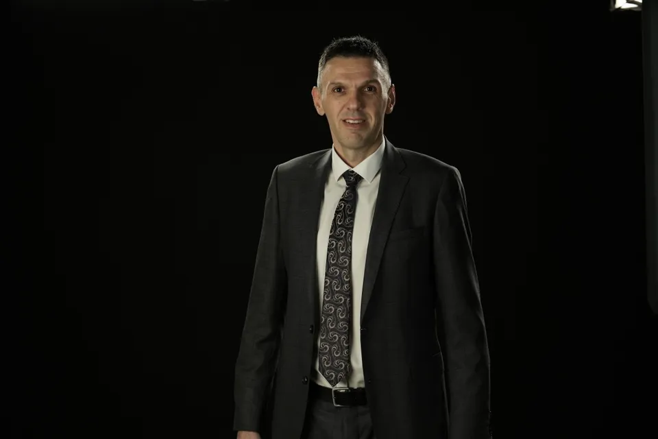 Lubo Bali, AI and data platform engineer, in a dark suit